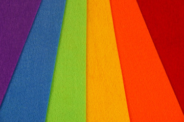 Abstract geometric pattern created with crafting felt in the LGBT rainbow flag colors of red, orange, yellow, green, blue and purple 