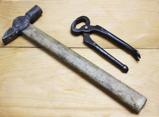 top view tools isolated on wooden background. Old cutting pliers and hammer
