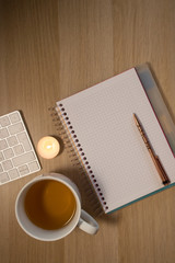 notebook and cup on wooden table
