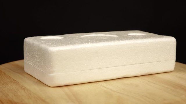 a piece of rectangular styrofoam lying horizontally rotates 360 degrees
