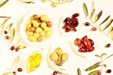 olive products -  oil, dried olives, pickled, stuffed with cornichons. top view