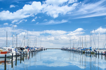 Fototapeta na wymiar Dragor Denmark. Parking for yachts and boats near the pier. Beautiful cloudy sky. Sunny day. Water Transport T