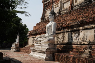 Fototapeta na wymiar white seated stone statue of Buddha Within the area of ​​Wat Yai Chaimongkol, Ayutthaya Thailand