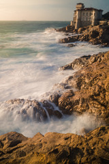 italian castle on the cliffs at sunset