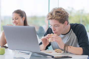 Young man eating a sandwich