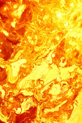 Abstract golden orange background. Flashes in the sun, liquid fire. Flowing lava colors paint
