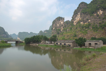 Fototapeta na wymiar Panoramic view of karst formations and rice paddy fields in Tam Coc, a part of Trang An Complex , was declared a UNESCO World Heritage Natural and Cultural Monument.Ninh Binh province, Vietnam