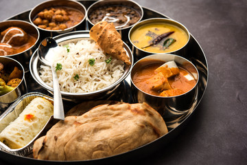 Indian vegetarian Food Thali or platter includes paneer butter masala, dal makhani / tarka, chole...