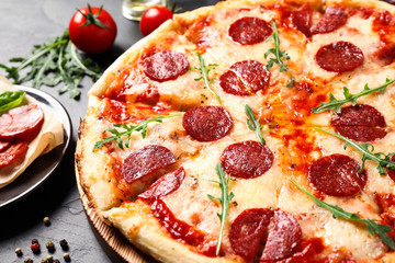 Hot delicious pepperoni pizza on dark table, closeup