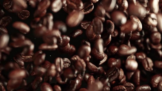 Super Slow Motion Shot of Exploding Premium Coffee Beans Towards the Camera at 1000fps.