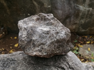 Stone formed from limestone and shale. There is noise and grain caused by the texture of the stone.