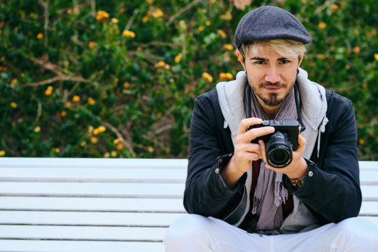Portrait Of Hipster Street Photographer Holding Mirrorless Camera