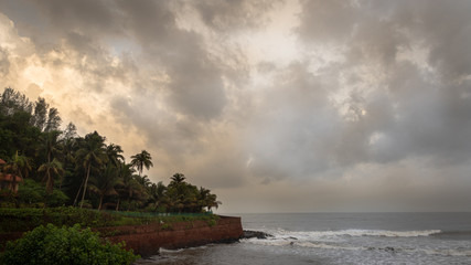 Landscape of the seashores of Goa with sky, clouds and palm trees during monsoon - obrazy, fototapety, plakaty