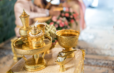 Thai wedding accessory for cultural wedding ceremony, luxury chair for bride and groom, golden tray with pedestal and the others. image for wedding objects, copy space and advertisement.