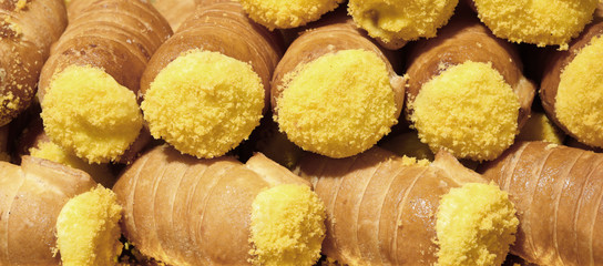many pastries with yellow fresh custard for sale