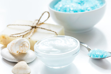spa composition with blue sea salt and natural soap on white desk background