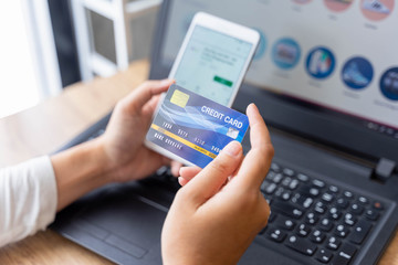 woman holding credit card and use phone for with shopping online. Online payment concept.