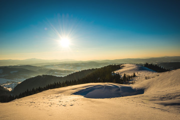 Fototapeta na wymiar Bright picturesque sunny panorama of ski slopes