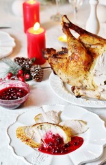pieces of turkey with cranberry sauce on a plate on Christmas Day. turkey for Christmas. New Year's and Christmas table with turkey in white tones.