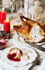 pieces of turkey with cranberry sauce on a plate on Christmas Day. turkey for Christmas. New Year's and Christmas table with turkey in white tones.