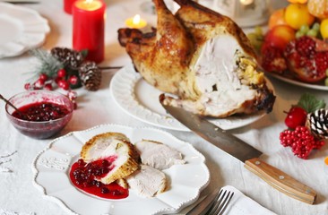 pieces of turkey with cranberry sauce on a plate on Christmas Day. turkey for Christmas. New Year's and Christmas table with turkey in white tones.