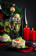 Christmas table setting. Traditional Russian salad "Olivier". New Year salad. Festive salad.