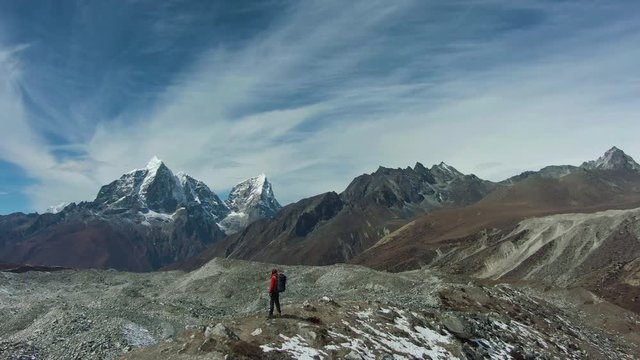 Ama Dablam Mountain, Lhotse South Face and Hiker Man on Sunny Day. Blue Sky. Himalaya, Nepal. Aerial View. Drone is Orbiting