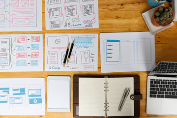 Top view of Creative flat lay UX designer working space and office supplies. Smartphone application...