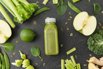 healthy eating, food and vegetarian diet concept - bottle of fresh green juice or smoothie, fruits...