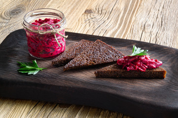 beet mayonnaise snack in glass jar served with garlic bread decorated with parsley