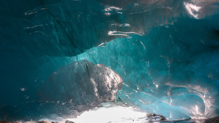 beautiful blue ice glacier cave grotto inside the mountain glacier Alibek, Dombay