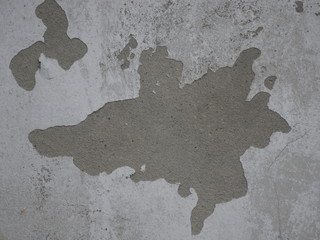 Dark Plaster Wall With Dirty White Black Scratched Horizontal Background. Old wall With Peel Grey Stucco Texture. Plastered Walls With Damages.  A Time Shattered Plaster.