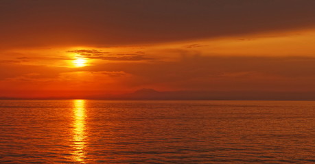 Sunset over the sea in the distance
