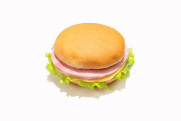 Sandwich with ham, cheese, lettuce on white background.