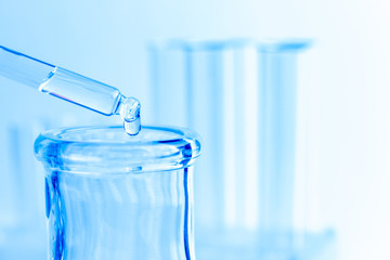 Science laboratory test blue tubes, macro flask equipment. Chemical dropper