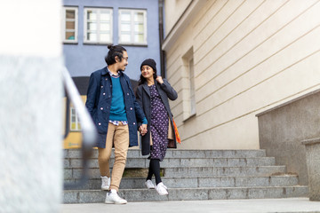 Happy young couple, walking through the old city, Warsaw, Poland