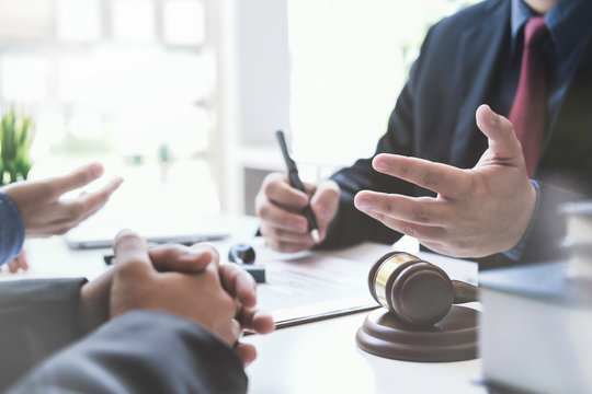 Justice lawyer meeting with contract papers and Judge gavel on tabel in courtroom. Attorney working in courtroom. Justice and law, attorney, court judge concept.