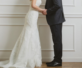 Fototapeta na wymiar Elegant bride and groom posing together