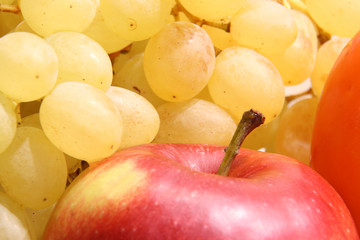 Naklejka na ściany i meble Ripe yellow grapes and red apple