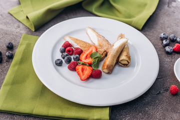 Breakfast. Pancakes with berries and strawberries, cottage cheese.