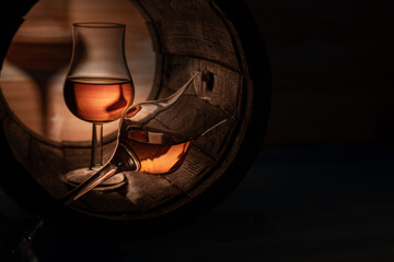 Two glasses of whiskey in an oak barrel