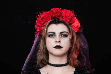girl witch in a wreath of red roses - 303903916