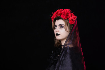 girl witch in a wreath of red roses - 303904104