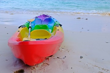 Obraz premium Colorful kayak on the beach with blue sea as background.