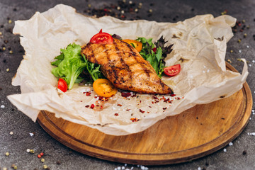 Grilled steak and vegetables on a dish with brown bread. 