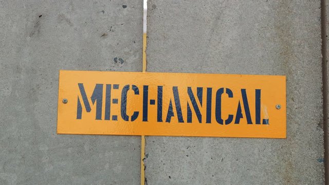 Video of a Yellow Signage Saying MECHANICAL Against Concrete Wall