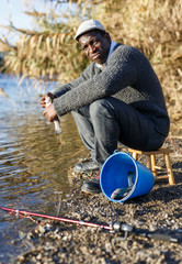 Friendly mature Afro fisherman