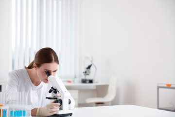 Fototapeta premium Scientist using modern microscope at table. Medical research