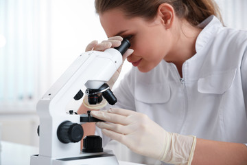 Scientist using modern microscope at table, closeup. Medical research