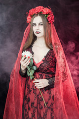 witch vampire girl in red dress with red veil - 303910709